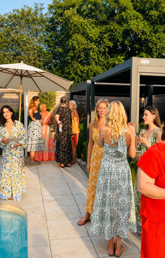 Guests gathering beside the Red House pool and garden