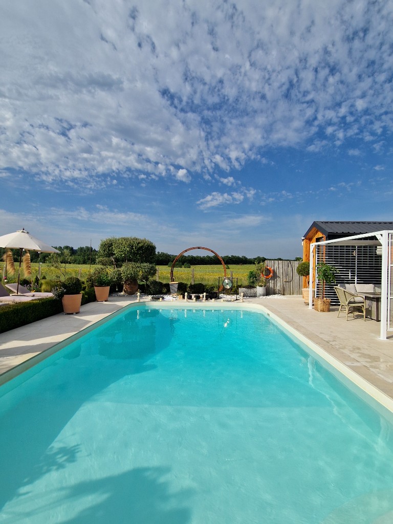 Aerial view of Red House Beach Pool with pergola and open countryside