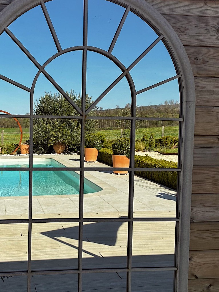 Red House pool seen through an arched window